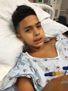 Jayden Nosrati in hospital bed getting treated for JNA